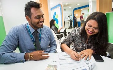 Member of staff helping customer to complete forms
