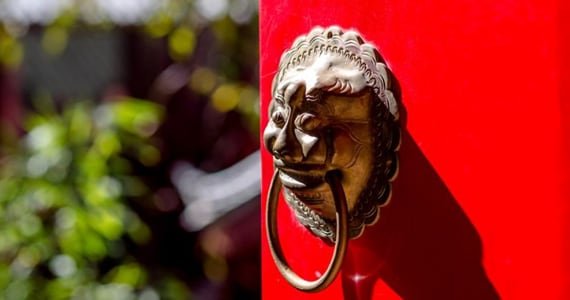 Door knocker on red wall