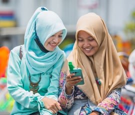 Two women looking at image on phone