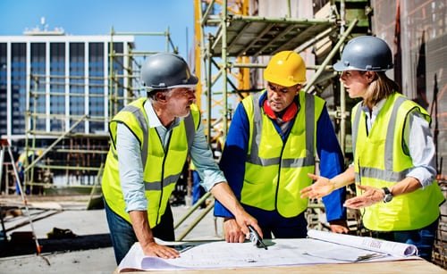 Engineers reviewing building plans