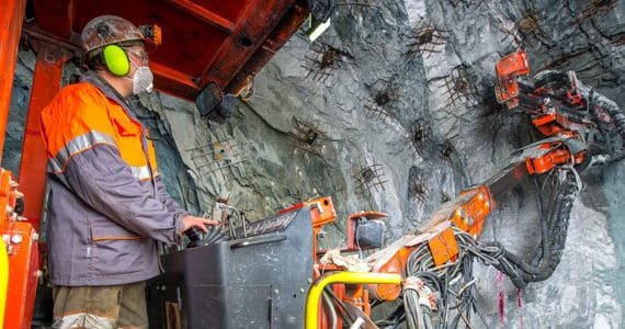 Man operating mining machine