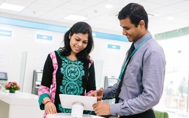 Two people in branch discussing business finance solutions