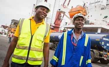 Two workers supported by Standard Chartered’s sustainable economic growth framework