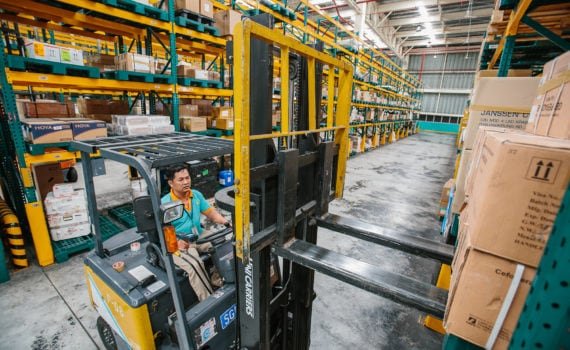 Warehouse working lifting boxes
