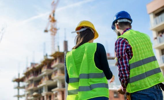 Construction worker and his manager checking the progress